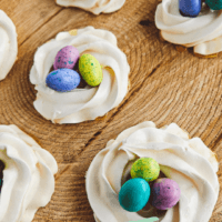 meringue nest with small candies inside the pipped egg whites.