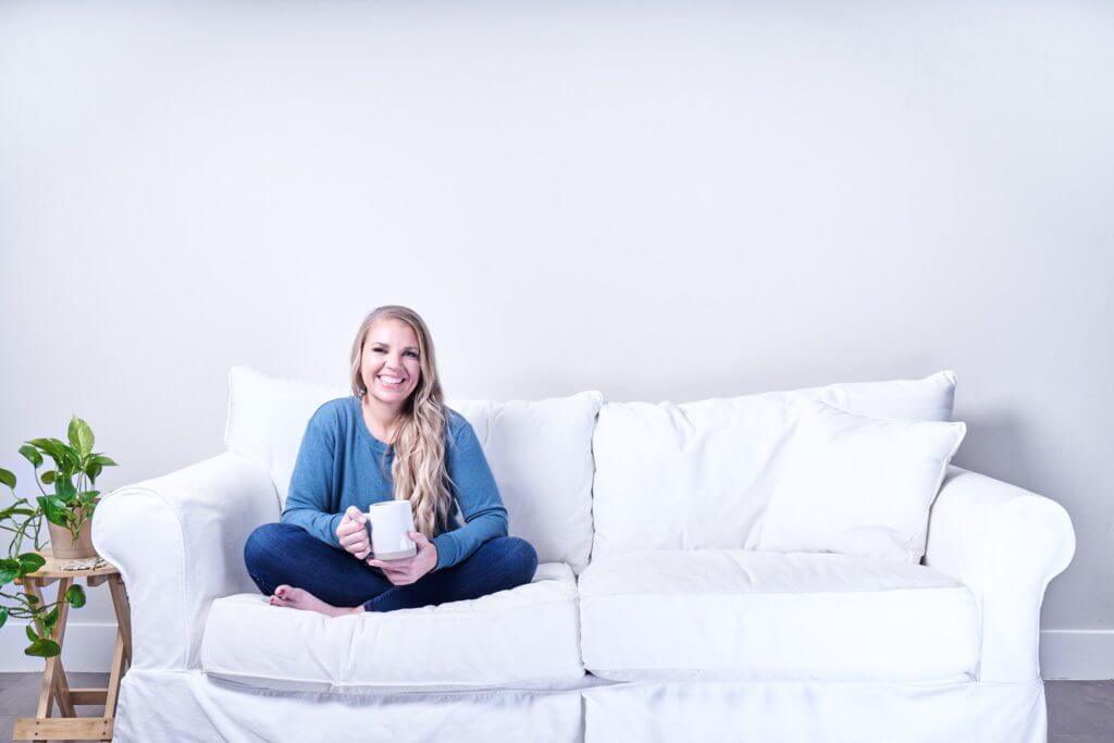katie wells smiling on couch